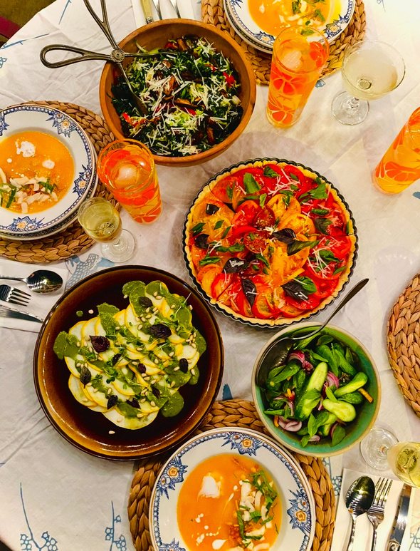 A family table set with colorful seasonal dishes